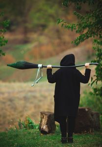 image of person with a broomstick on their shoulder